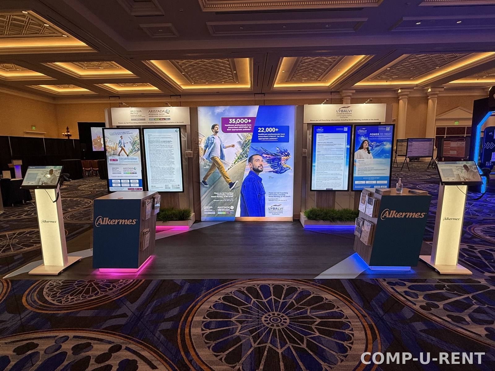 Full trade show booth build with screens, lighting, and staging
